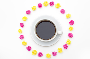 Cup of black coffee pink yellow roses laid out around on a white background. romantic love background for Valentine's day, birthday, holiday, party, wedding