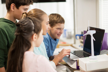 children with laptop and wind turbine at school
