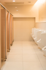 Public clean modern white male toilet, restroom with urinals, in