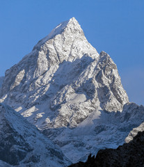 Snowy peak on the background of blue sky in the morning (view from Tengboche monastery) - Nepal,...