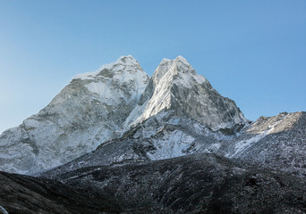 View of the Pokalde (5806 m) and Mehra Peak (5820 m) from the village of Dingboche in the valley...