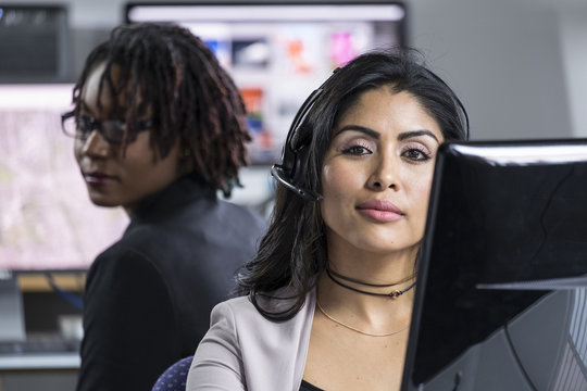 Portrait of a hispanic woman wearing a headset at work in an office