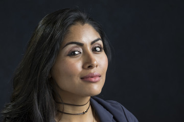 Fototapeta premium Portrait of a hispanic woman, smiling, looking at the camera