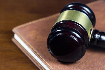 Law gavel on brown leather book (Justice concept)