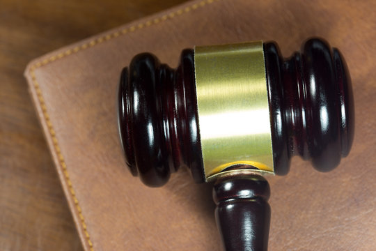 Law gavel on brown leather book (Justice concept)