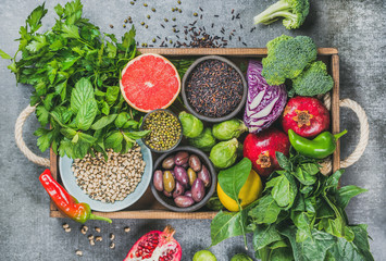 Vegetables, fruit, seeds, cereals, beans, spices, superfoods, herbs, condiment in wooden box for vegan, gluten free, allergy-friendly, clean eating and raw diet. Grey concrete background and top view © sonyakamoz