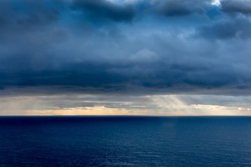 Obraz premium Bright sunlight over ocean, beautiful shine sun beam in sky, abstract blue natural background, peaceful skyscape, open heaven and God, morning sun rays, Mediterranean resort, panoramic sea