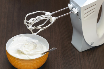 cooking cupcake meringue from egg whites and sugar with an electric mixer