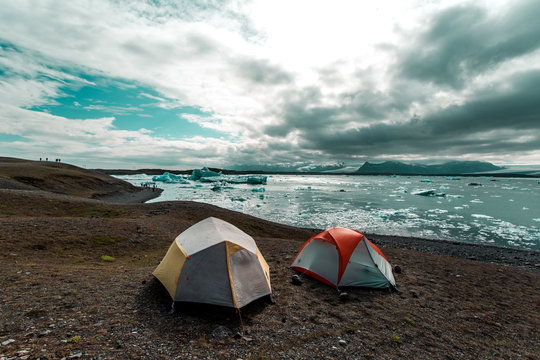 Two tents by shoreline 