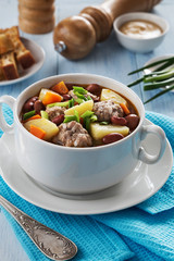 Bowl of soup with beans and meatballs