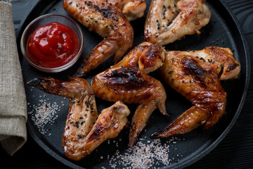 Close-up of grilled chicken wings with sesame, salt and sauce