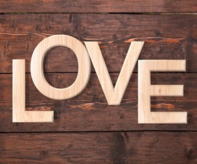 3D Wooden letters forming word LOVE written on wooden background. St. Valentine's Day.