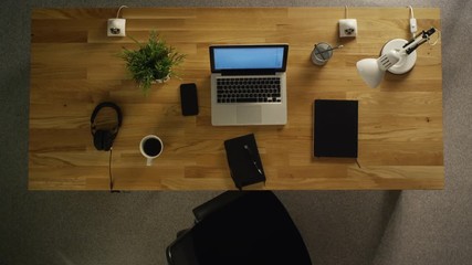 Top View of a Whole Working Day of a Creative Designer. Working on His Desktop Computer, Drinking Coffee, Going To Lunch, Writing Down Stuff in His Notebook. Shot on RED Cinema Camera in 4K (UHD). - Powered by Adobe