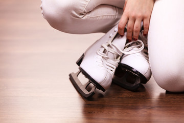 Woman with ice skates getting ready for ice skating