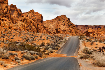 Empty Desert Road with mountains at Valley of Fire State Park, southern Nevada, USA