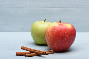 Apples and cinnamon on vintage background