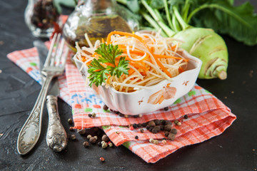 salad from a kohlrabi with carrots in a bowl on a table. selective focus. copy space.