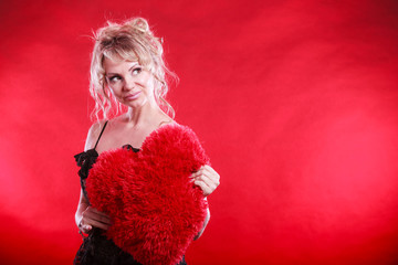 Woman holds big red heart love symbol