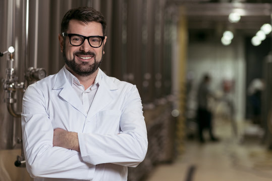 Smiling man posing in brewery