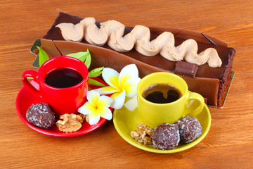 chocolate cake with two cup of coffee and chocolate balls