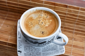 Aroma of freshly made coffee in cup and saucer and foam