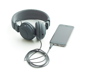 Gray vintage headphones and cellphone.