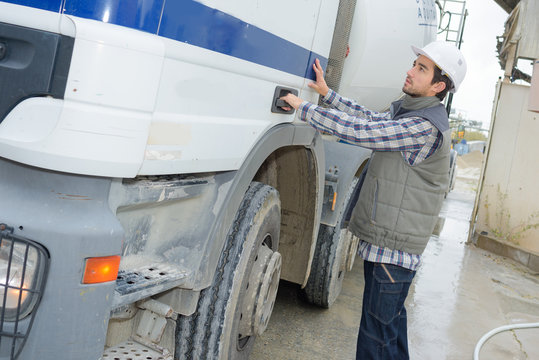 Driver opening door of cement transporting truck