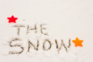 the written the snow / the word snow written on an expanse of snow