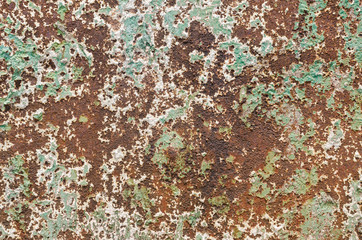 Grunge styled rusty old green and brown iron wall backgrounds of outdoor textured old damaged steel wall