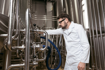 Concentrated man working with brewing mechanism