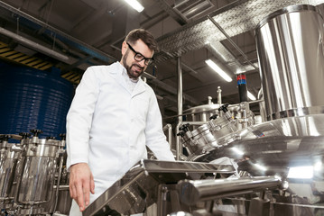 Smiling man looking at brewing mechanism