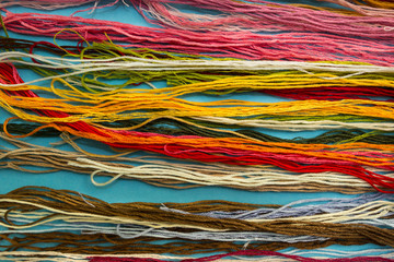 Parallel colorful cotton embroidery floss background, threads fo