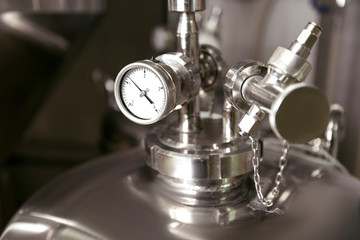 Close up of measuring gauge being used in brewery