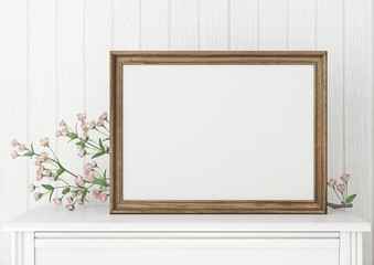 Horizontal interior mock up with empty wooden frame and blooming twig on wooden wall background. 3D rendering.