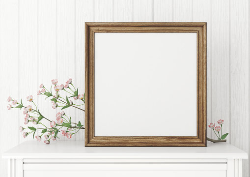 Square interior mock up with empty wooden frame and blooming twig on wooden wall background. 3D rendering.