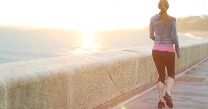 Young adult female running and stretching outdoors
