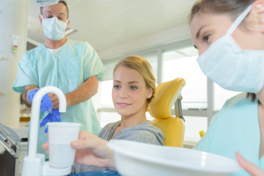 Dental Assistant Putting Water