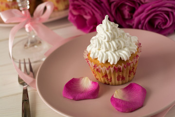 Sweet romantic cupcakes for Valentine's Day on a white wooden background. Selective focus