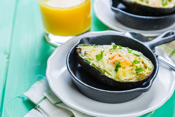 Breakfast - baked avocado with eggs, coffee and juice
