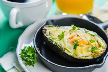 Breakfast - baked avocado with eggs, coffee and juice