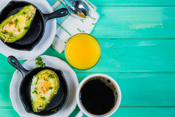 Breakfast - baked avocado with eggs, coffee and juice