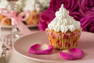 Sweet romantic cupcakes for Valentine's Day on a white wooden background. Selective focus