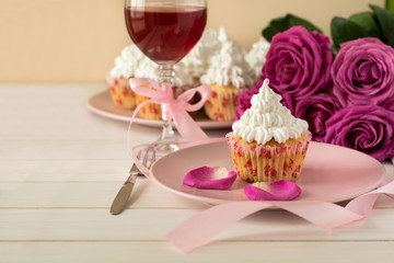 Sweet romantic cupcakes for Valentine's Day on a white wooden background. Selective focus
