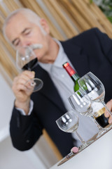 senior man tasting wine thinking deeply on life