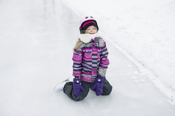 Fototapeta na wymiar little girl enjoying ice skating in winter season