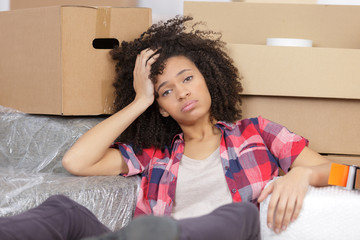 woman moving into new apartment house is bored and tired