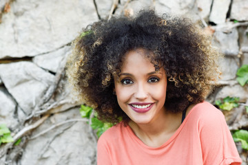 Black woman with afro hairstyle standing in an urban park