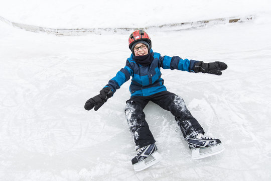 little boy enjoying ice skating in winter season