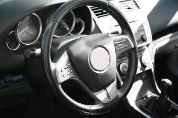Fototapeta na wymiar Steering wheel in car interior, closeup