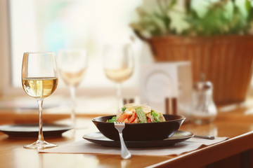 Plate with delicious salad on served table in cafe